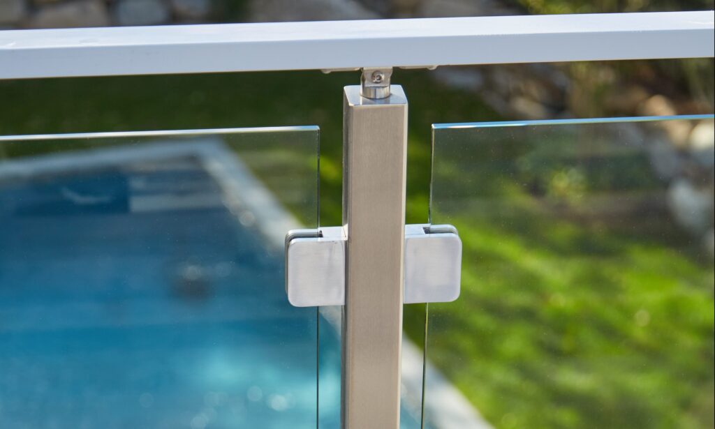 Glass railing post and clear glass panels