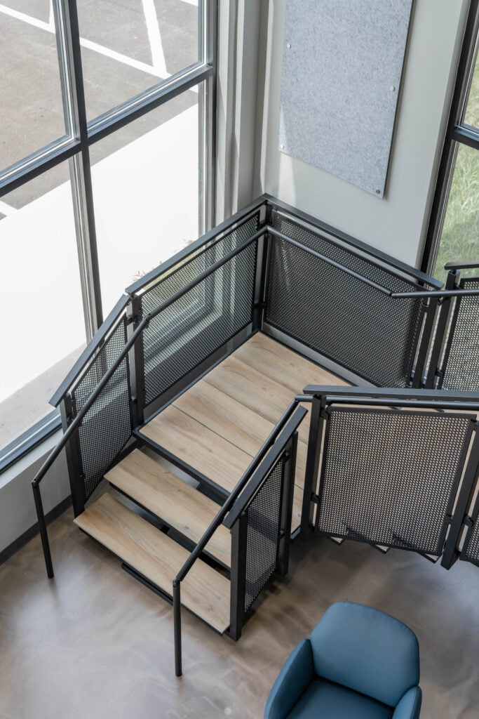 Floating Stairs made from Porcelain Treads and Perforated Railing Panels