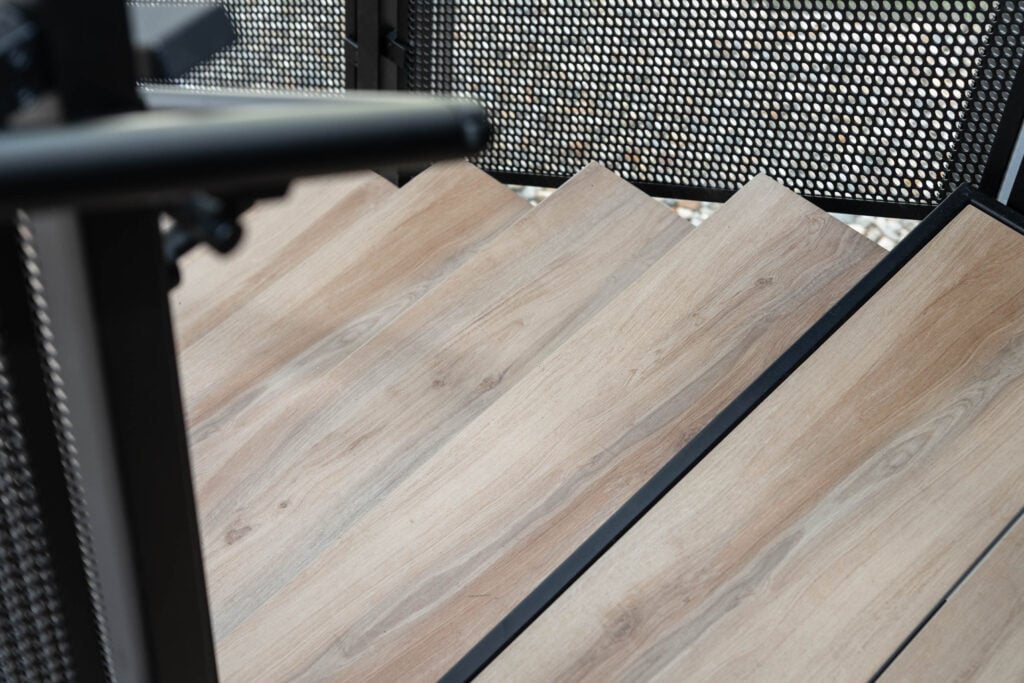 Floating Stairs made from Porcelain Treads and Perforated Railing Panels