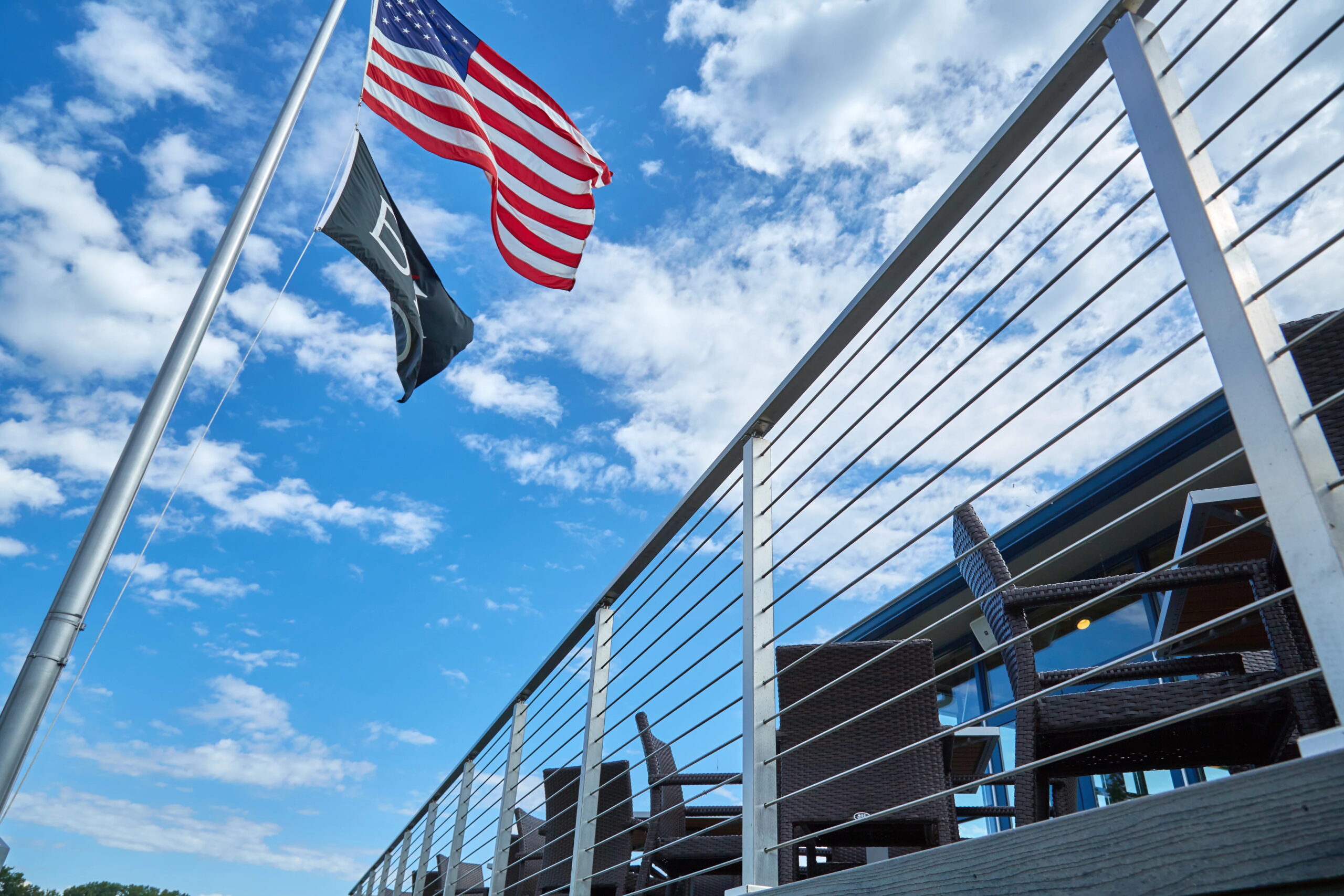 An American flag flies above a Viewrail railing.