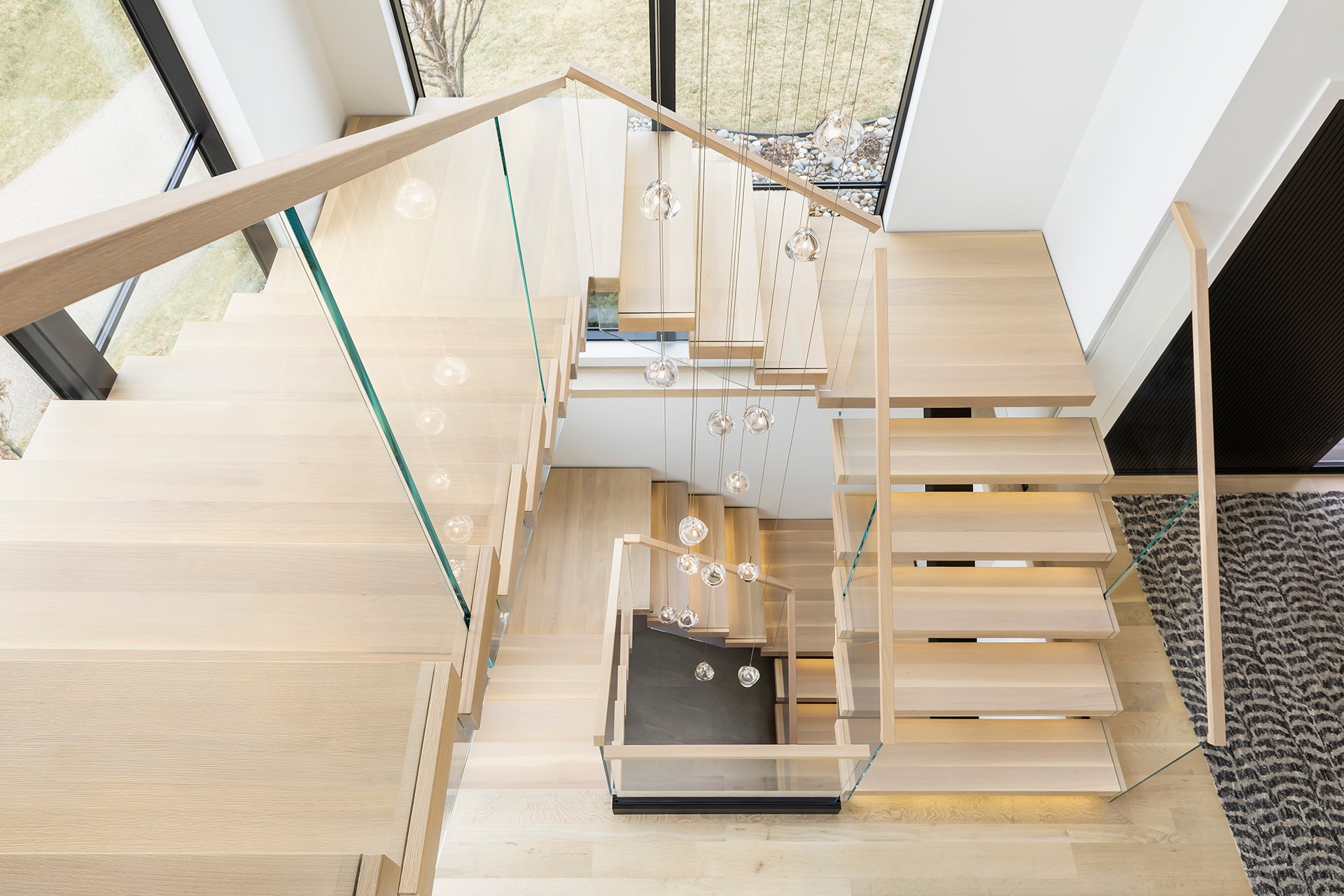 Viewrail Flight Mono System stairs and glass railing spiraling down to lower levels