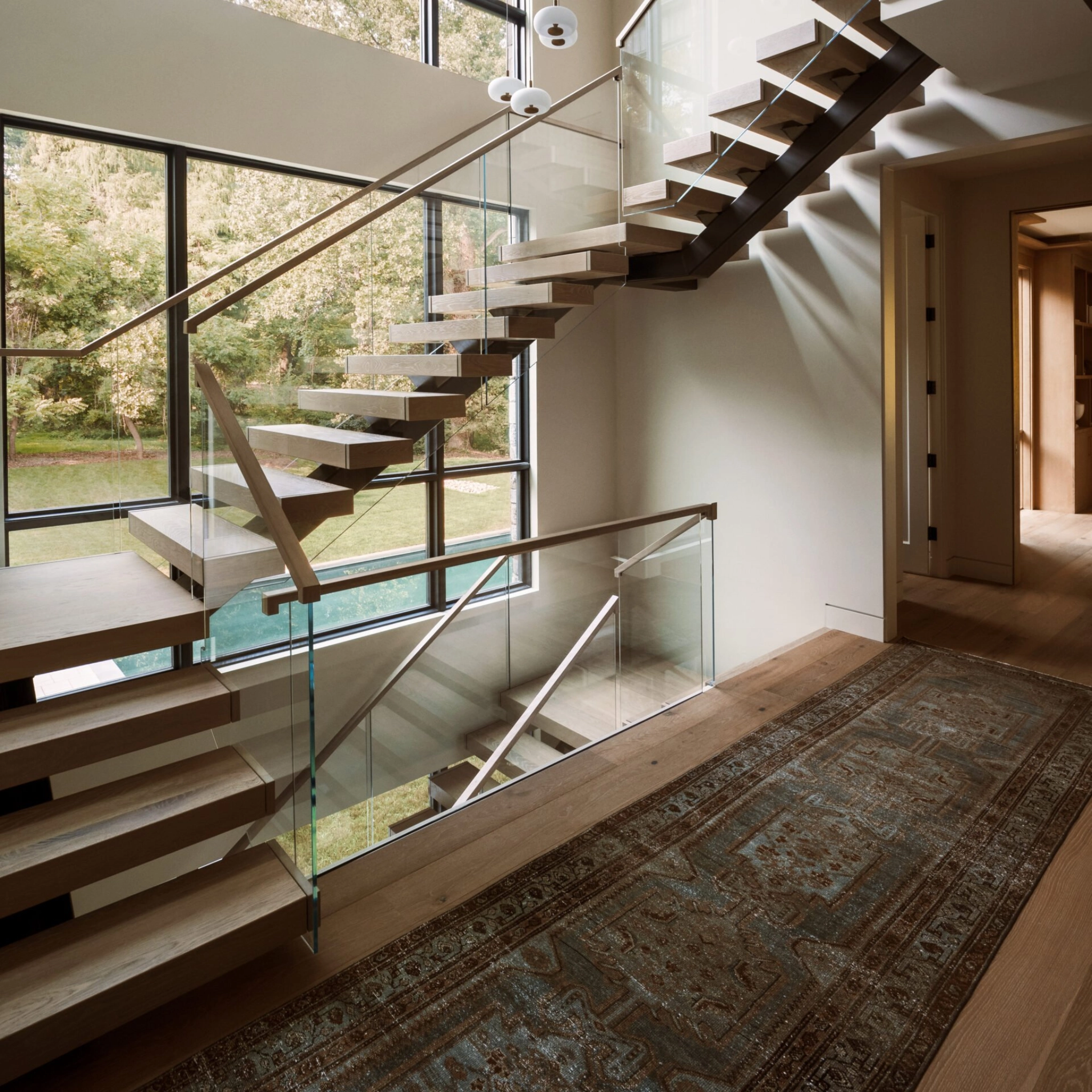 A U-shaped FLIGHT Mono system connecting three stories with large windows behind and a hallway in front.