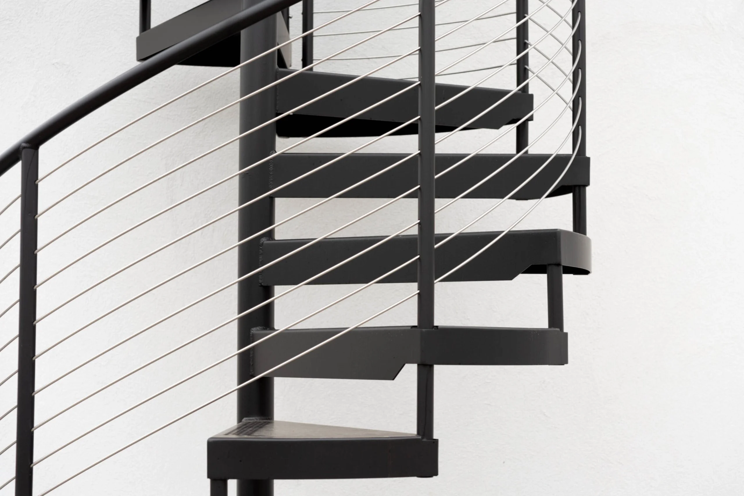 Close up of the curved rod railing on an exterior FLIGHT Spiral