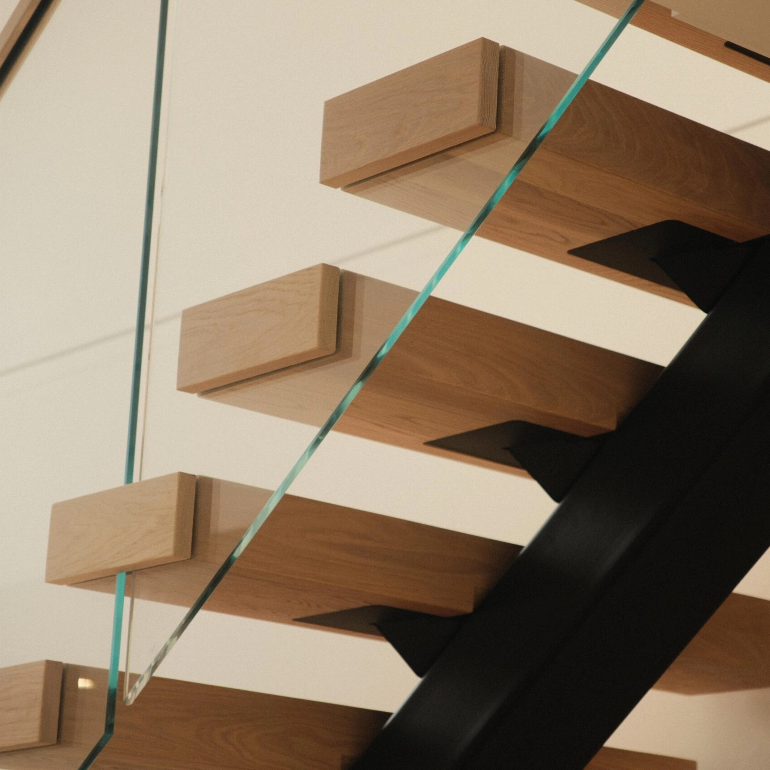 A shot of a FLIGHT Mono staircase with Vedera glass railing from underneath.