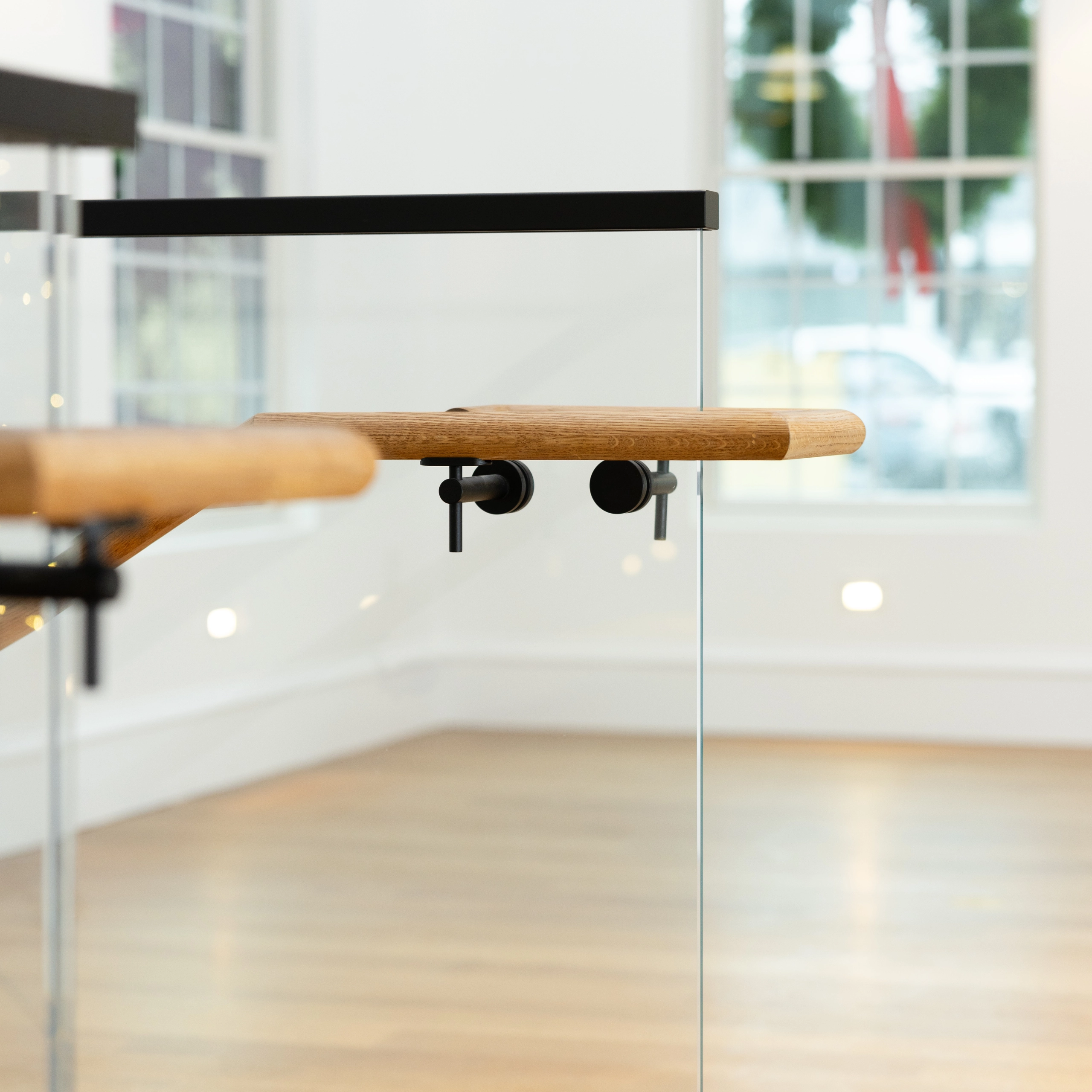 Integrated wood handrail in a commercial project, where an aluminum top cap exists as well.