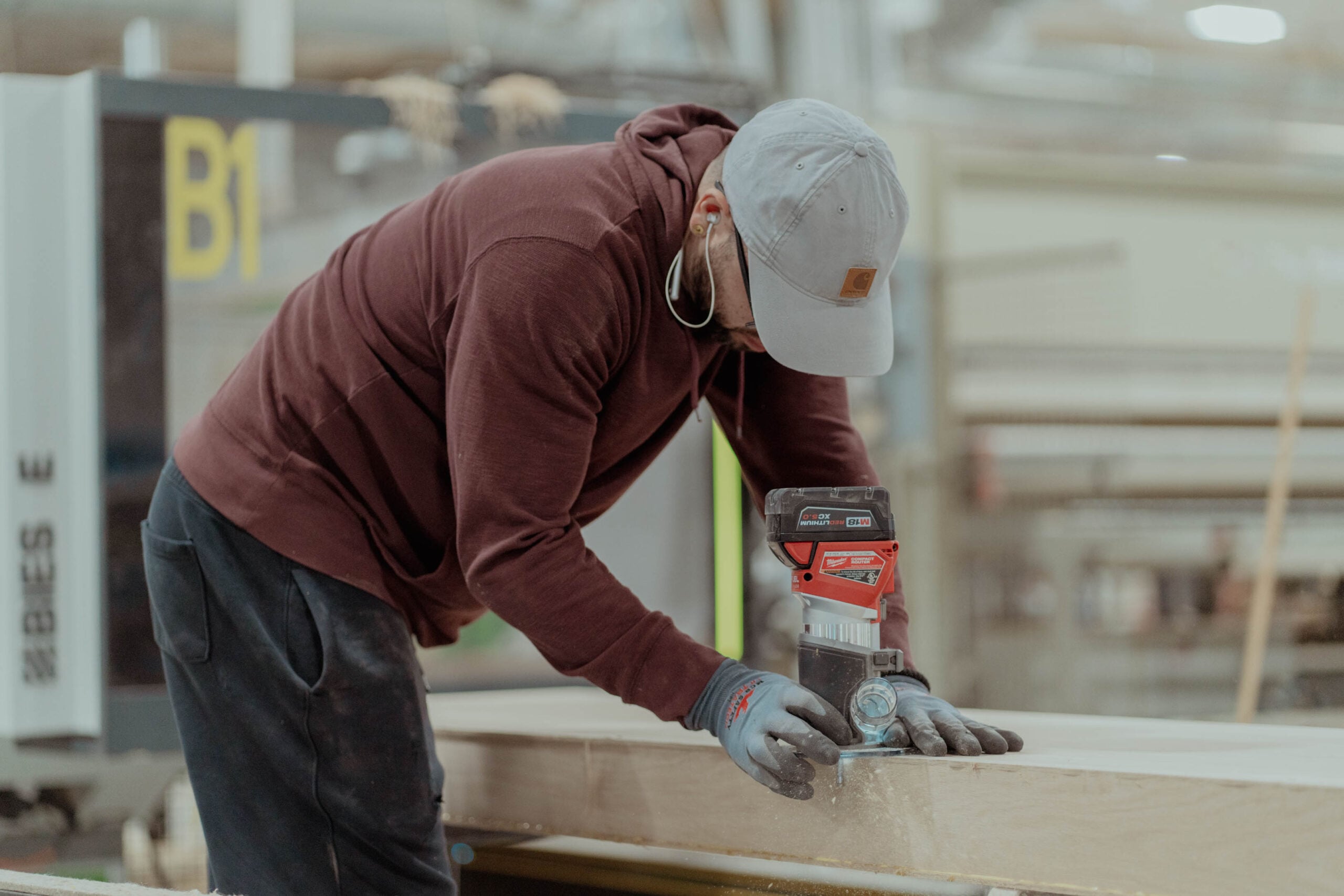 A craftsman sanding a hardwood tread